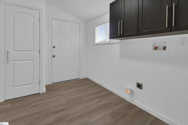 laundry room featuring hookup for a washing machine, electric dryer hookup, cabinets, and light hardwood / wood-style flooring