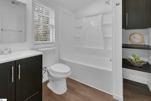 full bathroom featuring vanity, hardwood / wood-style floors, shower / bathing tub combination, and toilet