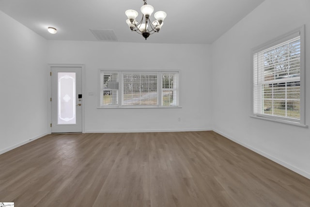 interior space featuring hardwood / wood-style floors and a chandelier