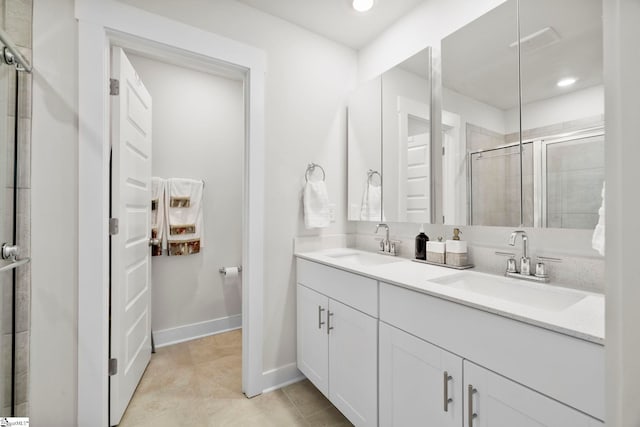 bathroom featuring vanity, tile patterned floors, and walk in shower