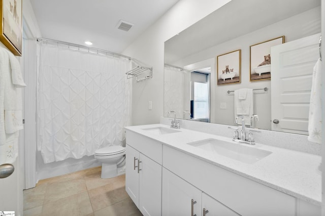 full bathroom with vanity, shower / tub combo, and toilet