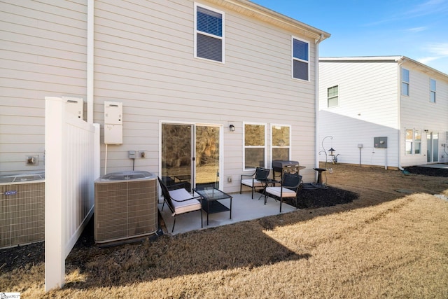 rear view of property featuring central AC unit and a patio area