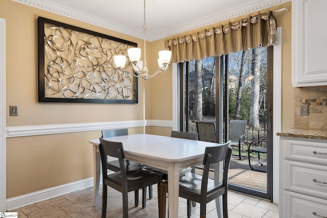 dining room with crown molding and a notable chandelier