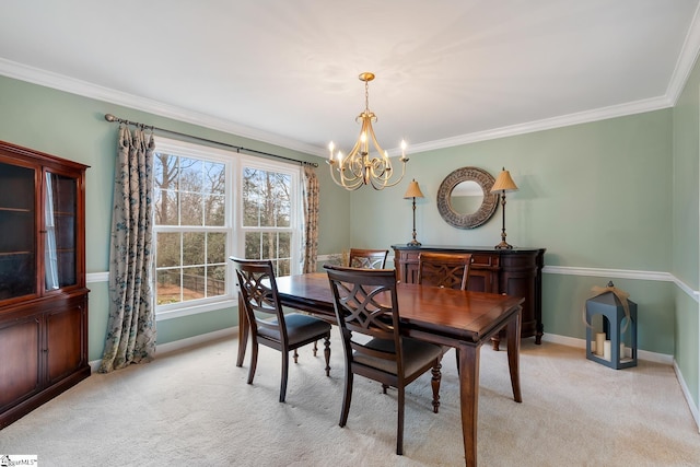 carpeted dining space featuring crown molding and an inviting chandelier