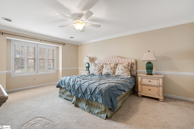 bedroom featuring ornamental molding, light colored carpet, and ceiling fan