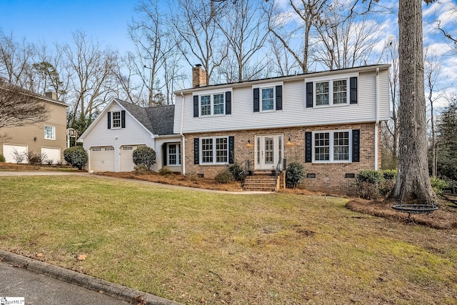 view of front of home featuring a garage and a front lawn