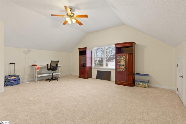 carpeted office with lofted ceiling, a textured ceiling, and ceiling fan