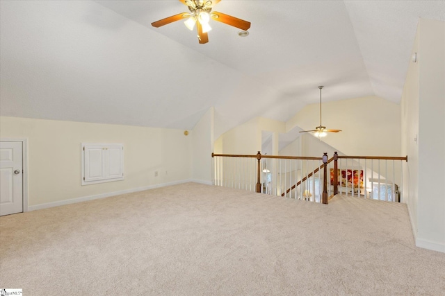 bonus room with lofted ceiling, carpet flooring, and ceiling fan