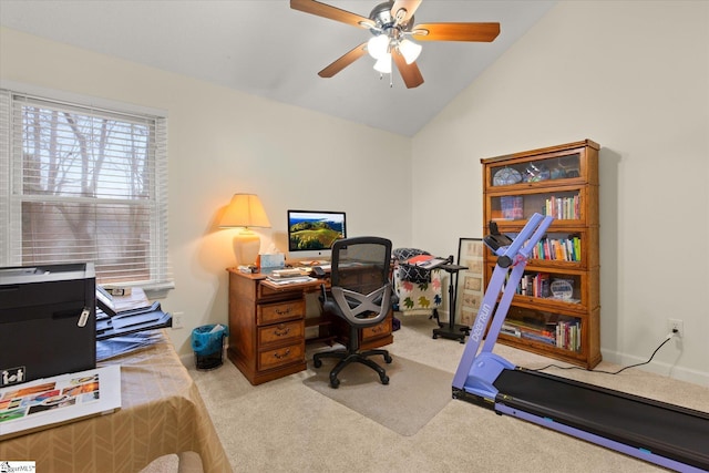 carpeted office space featuring lofted ceiling and ceiling fan