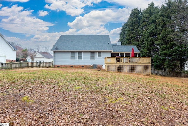 rear view of property with a wooden deck, a yard, and central AC unit