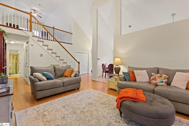 living room featuring a high ceiling and light wood-type flooring