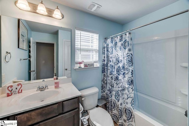 bathroom featuring shower / bath combination with curtain, visible vents, vanity, and toilet