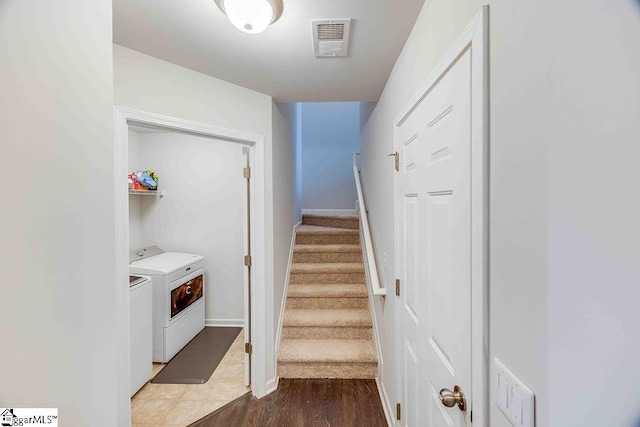 interior space featuring hardwood / wood-style floors and washing machine and clothes dryer