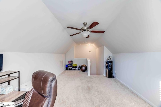 home office with ceiling fan, light colored carpet, and vaulted ceiling