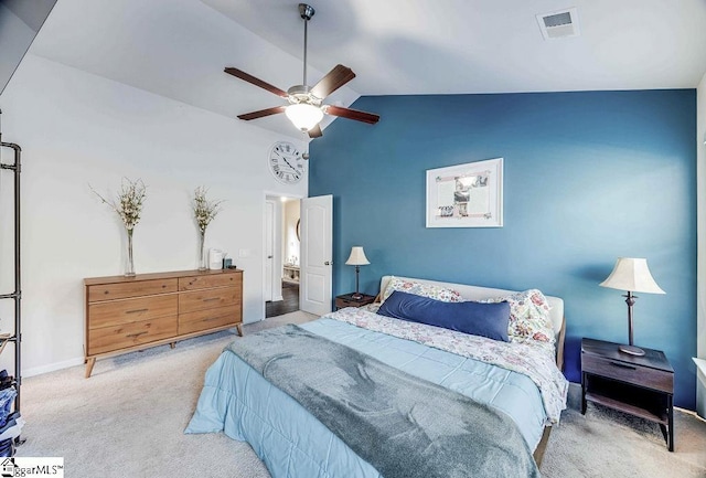 bedroom with light carpet, visible vents, baseboards, vaulted ceiling, and a ceiling fan