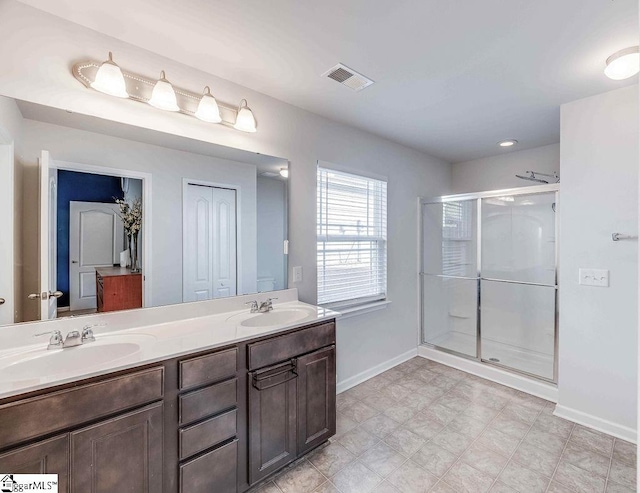 full bath with a closet, a sink, and a stall shower