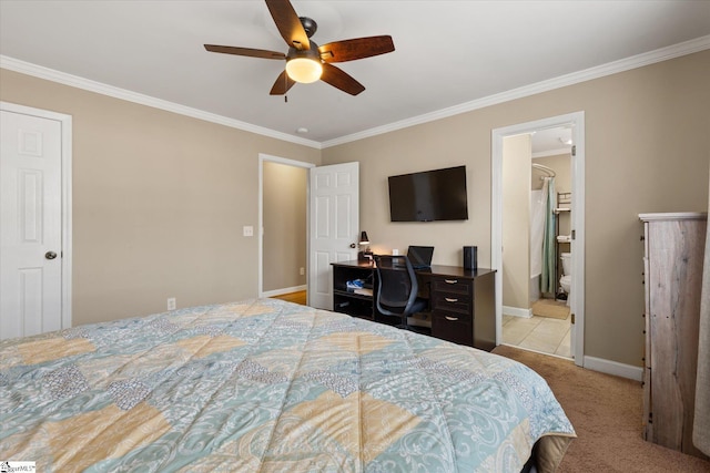 bedroom featuring ceiling fan, ornamental molding, light carpet, and ensuite bath