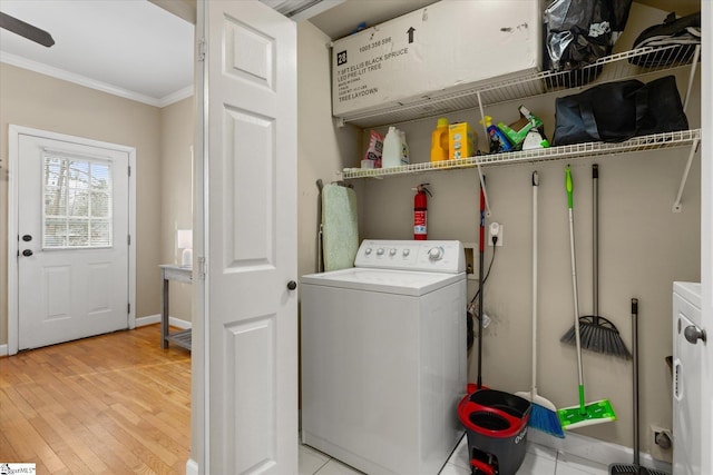 washroom with crown molding, washer / clothes dryer, and light wood-type flooring