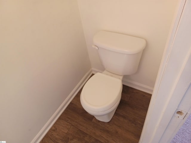 bathroom with hardwood / wood-style floors and toilet