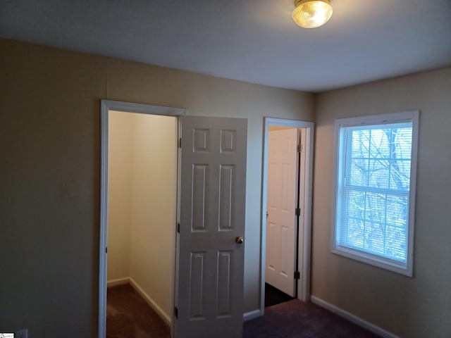 unfurnished bedroom featuring dark colored carpet