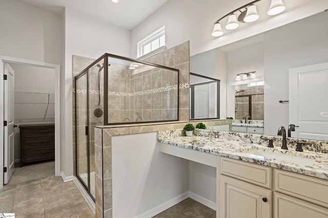 bathroom featuring an enclosed shower and vanity