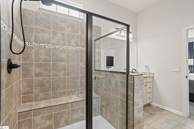 bathroom with vanity, a shower with shower door, and tile patterned floors