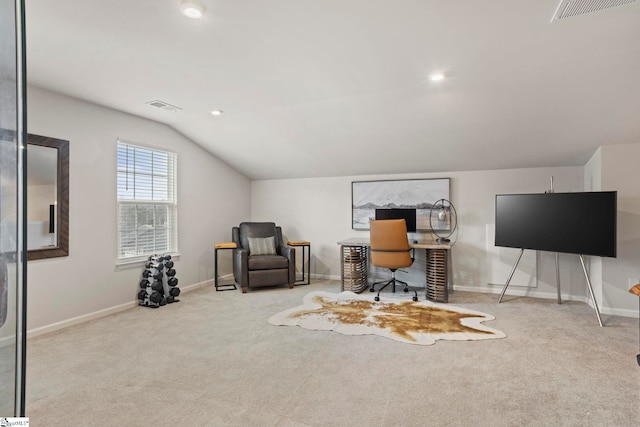 carpeted home office with vaulted ceiling