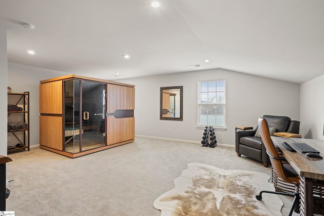 carpeted home office with lofted ceiling