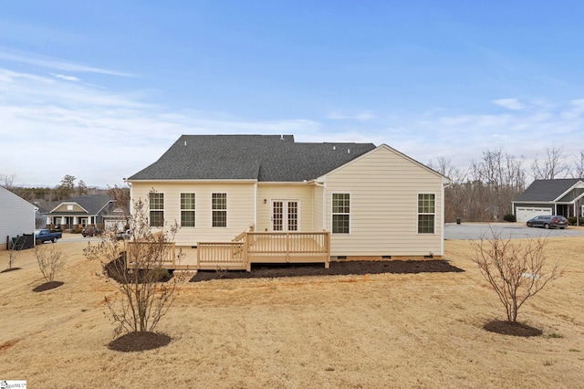 rear view of property featuring a wooden deck