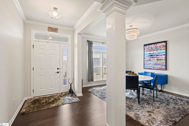 foyer entrance featuring decorative columns, crown molding, and dark hardwood / wood-style floors