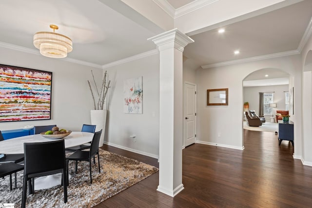 dining room featuring ornate columns, ornamental molding, and dark wood-type flooring