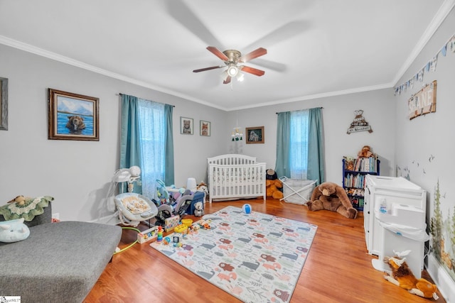 bedroom with multiple windows, ornamental molding, light hardwood / wood-style floors, and ceiling fan