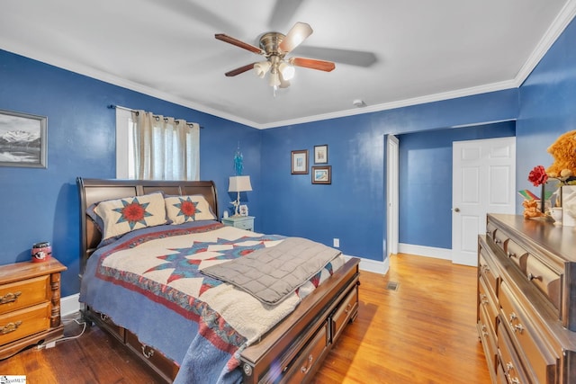 bedroom with ceiling fan, ornamental molding, and light hardwood / wood-style flooring