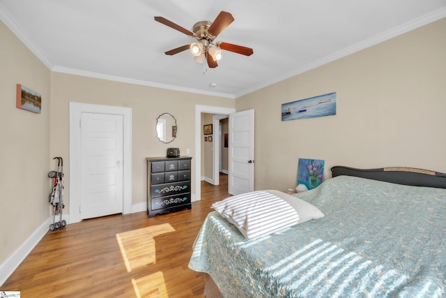 bedroom with crown molding, hardwood / wood-style flooring, and ceiling fan