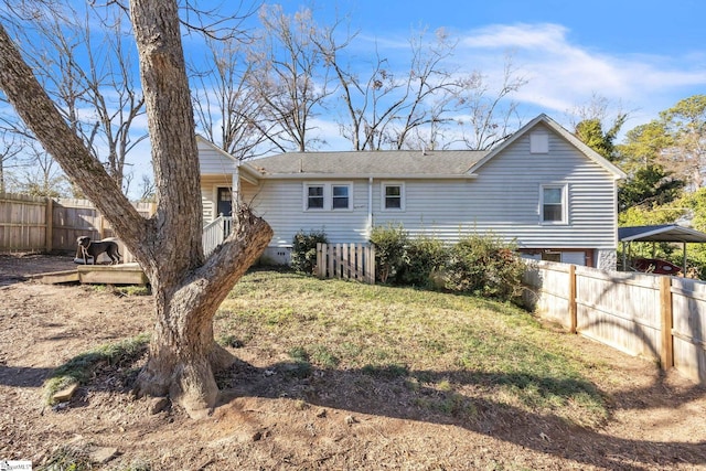 rear view of property with a yard and a carport