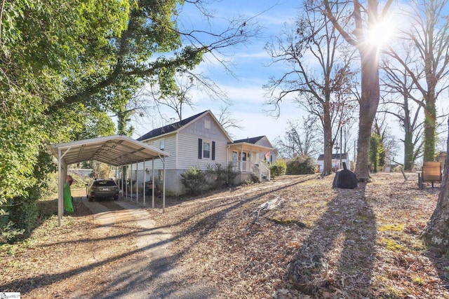 view of side of property featuring a carport and a porch