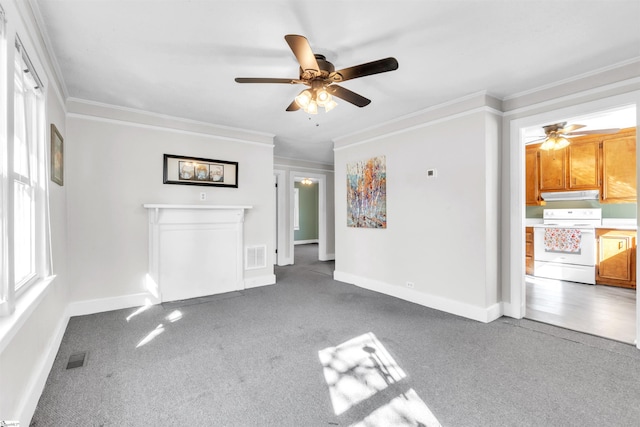 unfurnished living room with ceiling fan, ornamental molding, and carpet