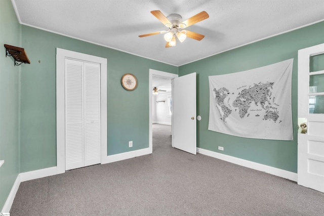 unfurnished bedroom featuring ceiling fan, carpet, and a closet