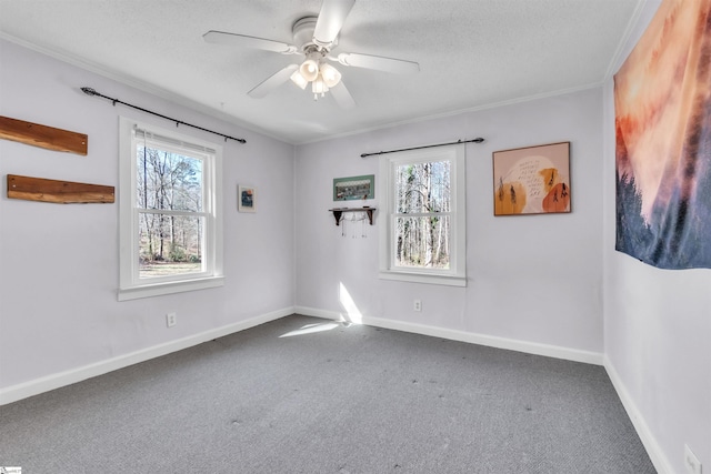 unfurnished room featuring ornamental molding, carpet, a textured ceiling, and ceiling fan