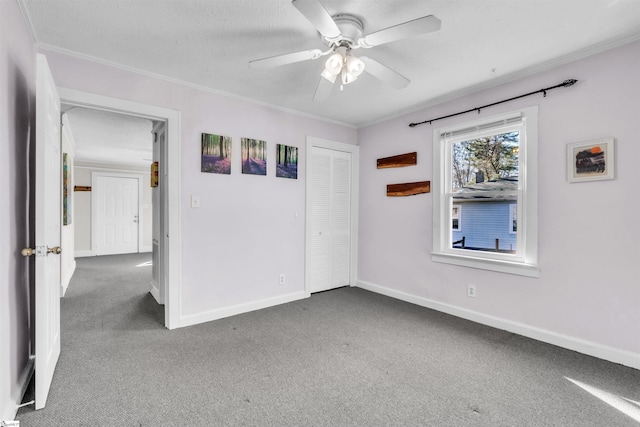 carpeted empty room featuring crown molding and ceiling fan