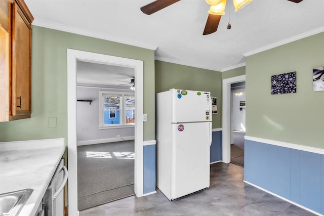 kitchen with dishwasher, sink, white fridge, ceiling fan, and crown molding