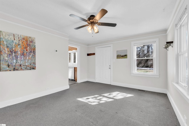 carpeted spare room featuring ceiling fan and ornamental molding