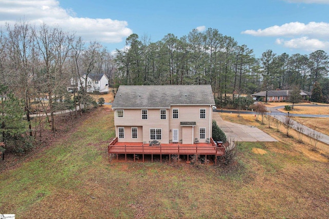 back of property with a yard and a deck