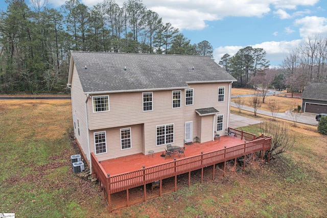 back of house with a wooden deck and a yard