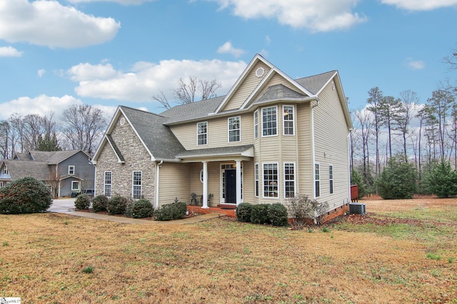 view of front of house featuring a front yard and cooling unit