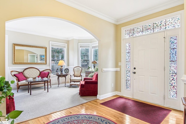 foyer featuring crown molding and hardwood / wood-style floors