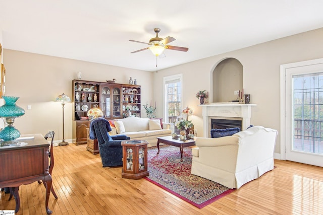 living room featuring light hardwood / wood-style floors and ceiling fan