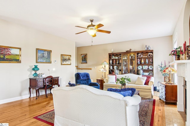 living room with light hardwood / wood-style floors and ceiling fan