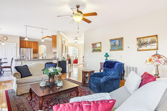 living room featuring ceiling fan and light wood-type flooring