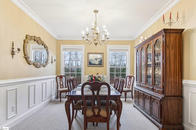 carpeted dining room featuring a notable chandelier and crown molding